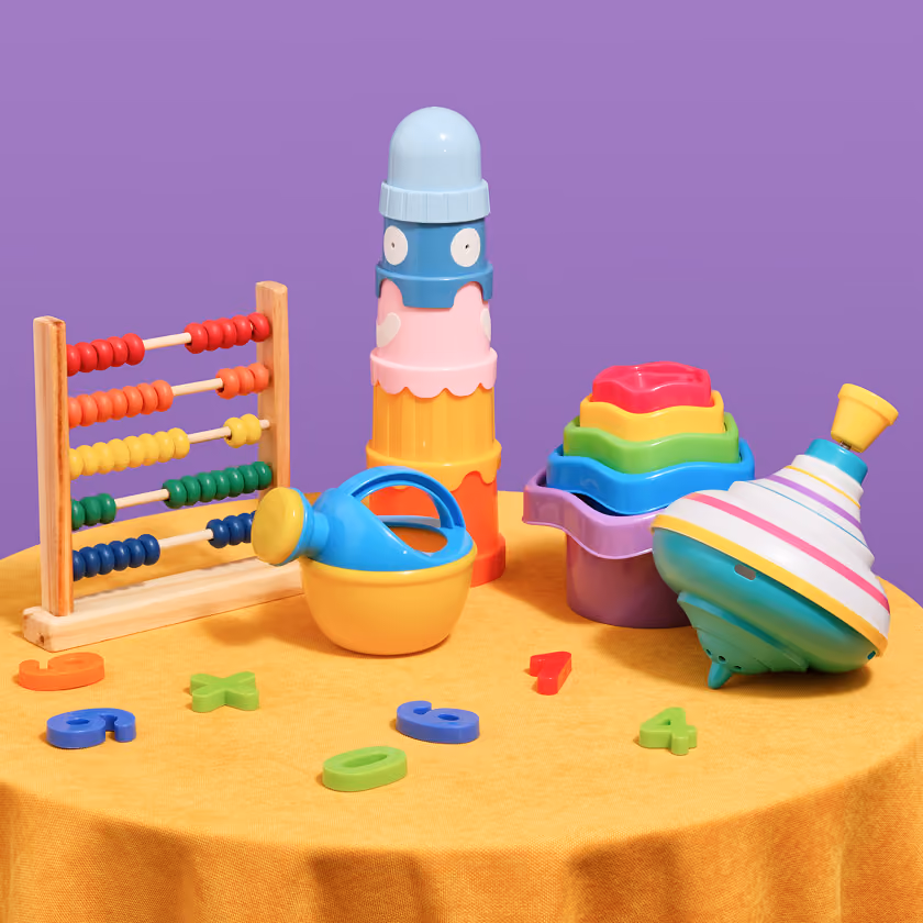 Colorful children's toys including an abacus, stacking cups, spinning top, and numbers on a yellow table.